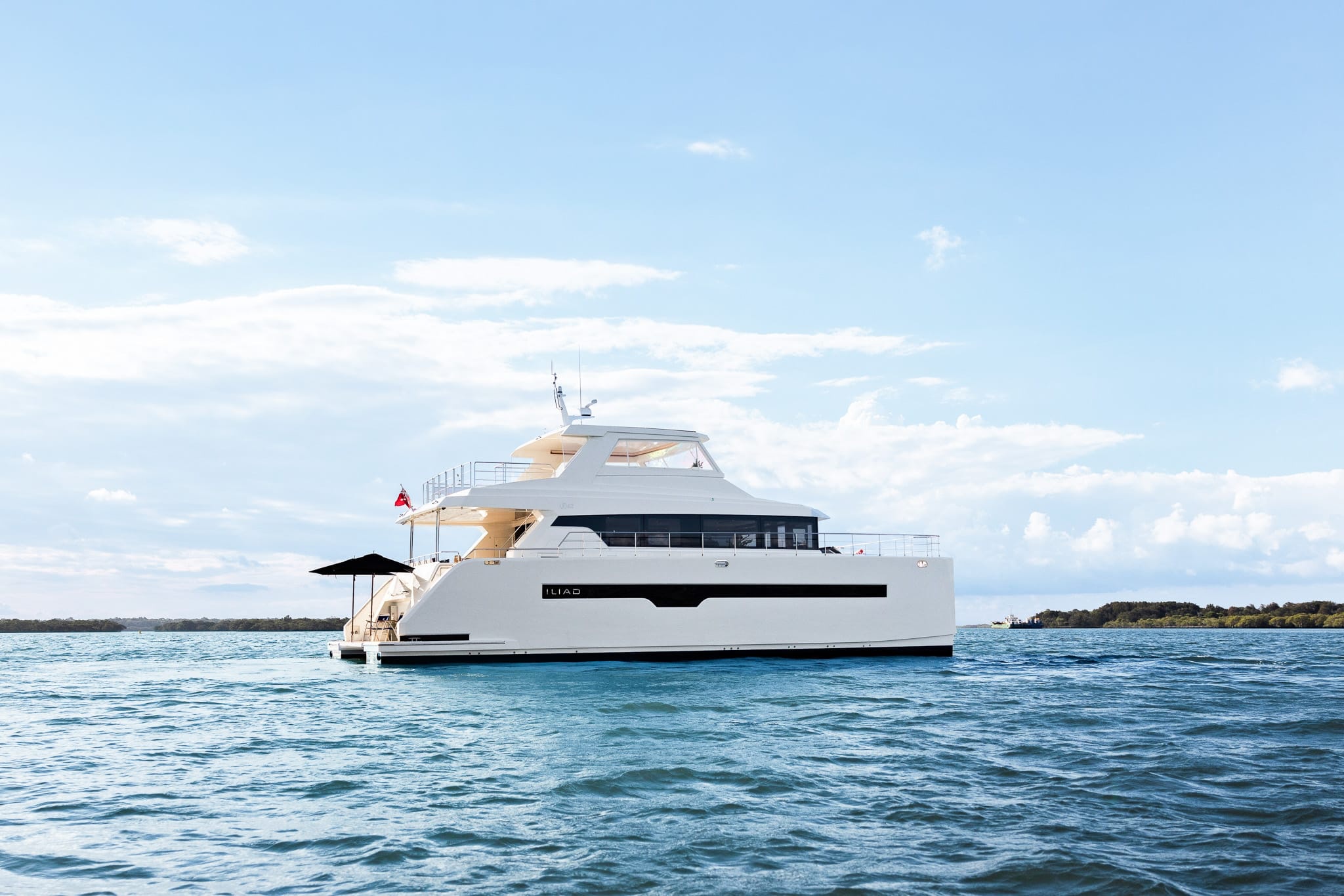 A full-profile motor yacht at anchor